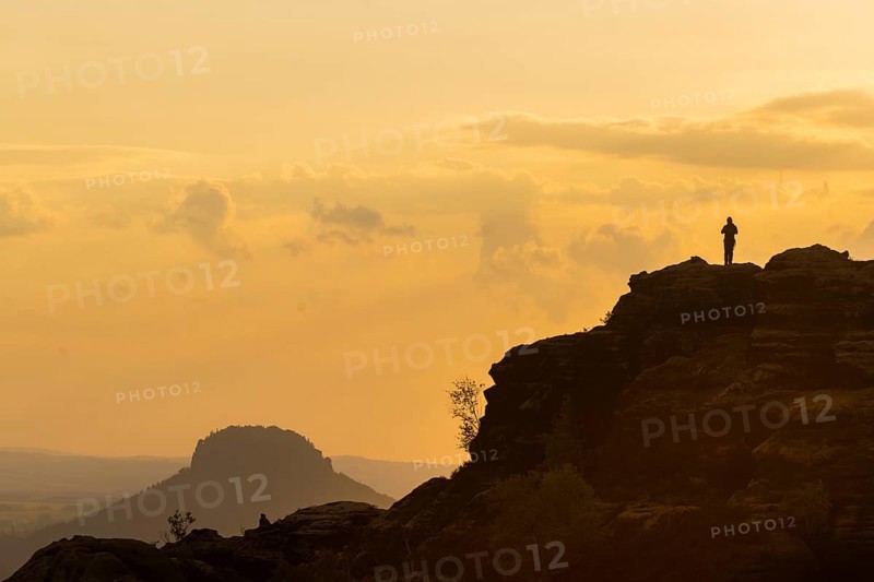 Climbers on the Schrammsteine in the Elbe Sandstone Mountains with the Lilienstein in the background