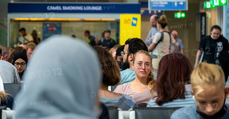 Waiting hall, Young woman waiting for her departure, Check-in, Munich Airport, Bavaria, Germany, Europe