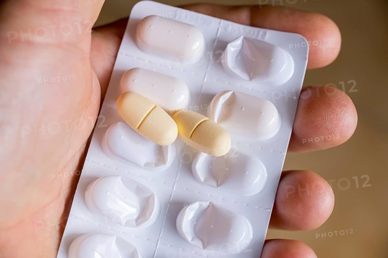 Hand holding a blister pack with tablets