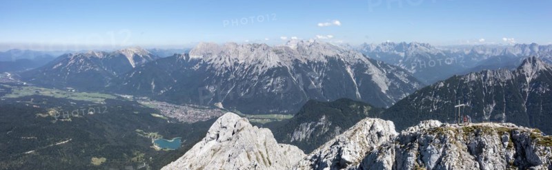 Aerial view, Alpine panorama, hikers at the summit cross, Westliche Wettersteinspitze, Wetterstein Mountains, Bavaria, Germany, Europe