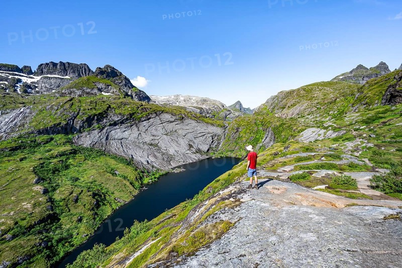 Mountaineers on the hiking trail to Munkebu hut, view of lake Tridalsvatnet and mountain landscape, Moskenesoya, Lofoten, Nordland, Norway, Europe