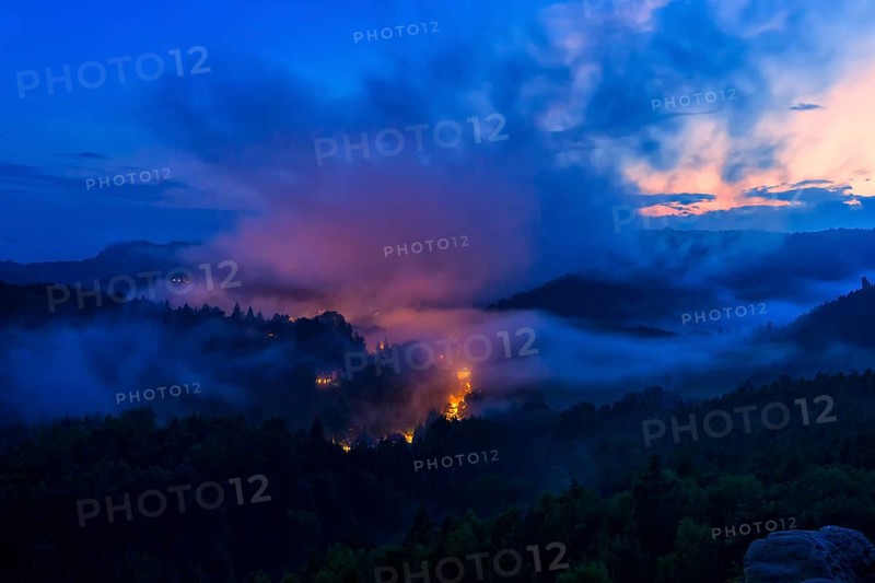 DEU Saxony Rathen Gamrig near Rathen under a full moon in the evening mist The Basteige area with the Gamrig is one of the most popular excursion destinations in the Saxon Switzerland National Park