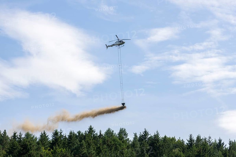 Symbolic image, climate change, helicopter, helicopter spreading finely painted limestone and wood ash against acid rain, mixed forest, container, soil protection liming, forest liming, Baden-Württemberg, Germany, Europe