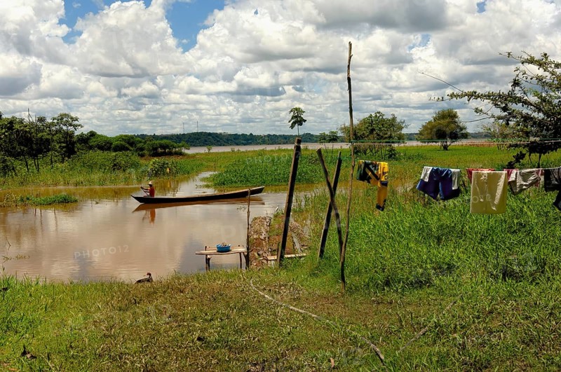 Man of caboclos tribe paddling in his canoe (Amazona) river, Amazon state, Brazil, South America