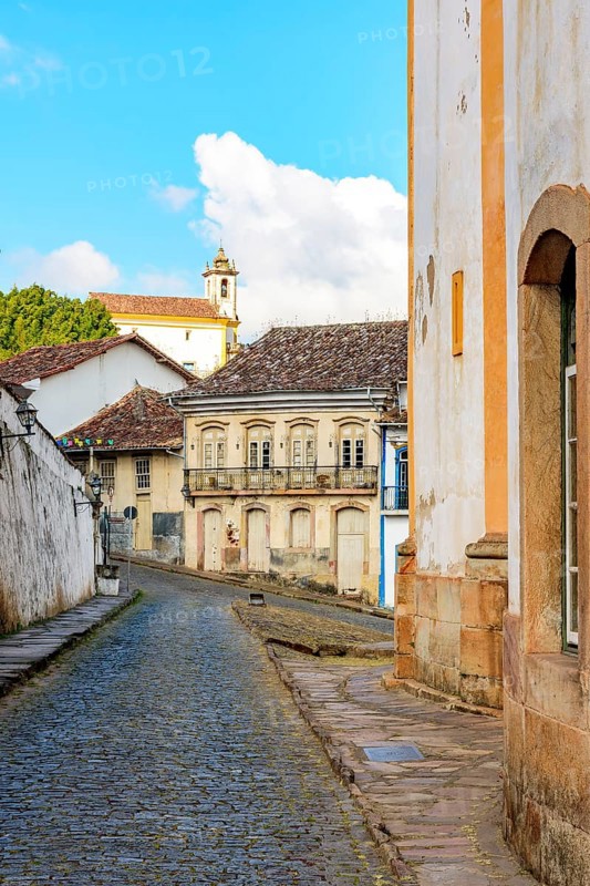 Cobbled streets between historic baroque churches and colonial style houses in the city of Ouro Preto in Minas Gerais