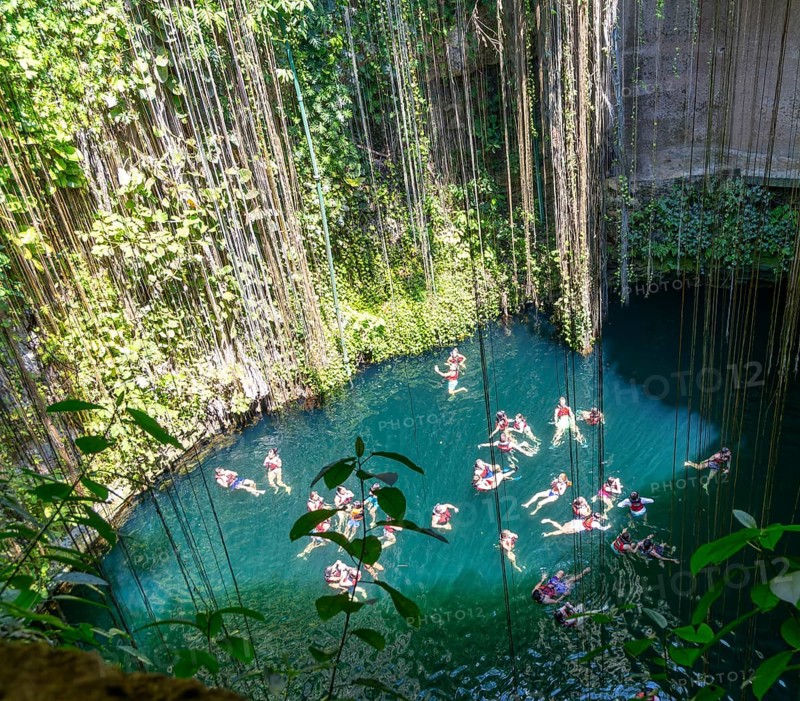 People swimming in limestone sinkhole pool, Cenote Ik kil, Pisté, Yucatan, Mexico, Central America