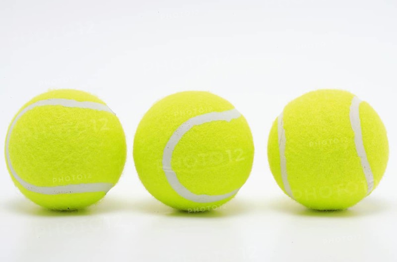 Sports equipment, three yellow tennis balls in a row