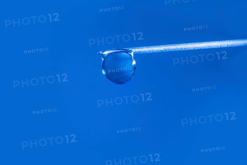 Macro image Covid vaccine, a drop of Moderna vaccine hangs on a vaccine needle