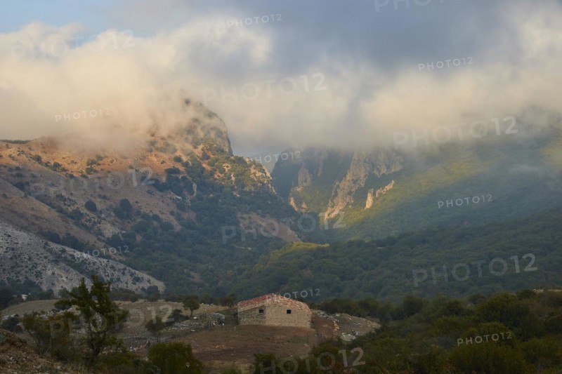 Fog, mountains, valley, green meadows, hut, light and shadow, foreground brightened, Madonie National Park, spring, Sicily, Italy, Europe