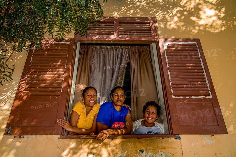 Young women looking out of window. San Felipe. Vulcano Fogo. Fogo. Cabo Verde. Africa