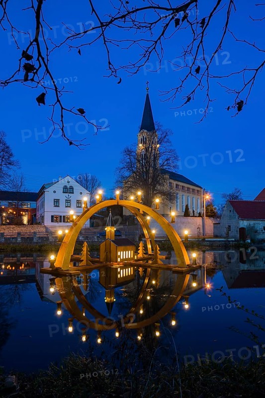 Floating candle arch in the village pond of Bärnsdorf near Moritzburg. The arch is 4.5m high, almost 8m wide and was built by local craftsmen as a special decoration for the local Christmas market