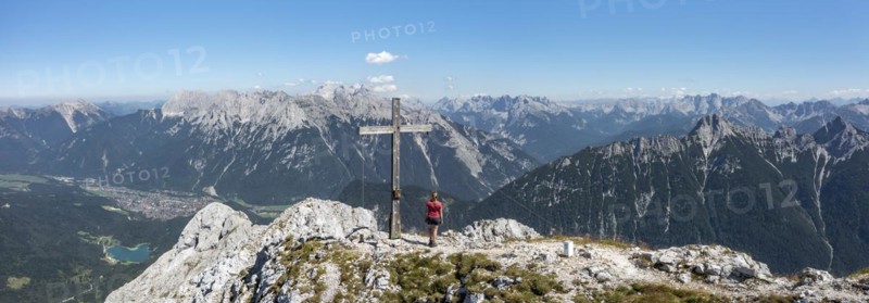 Aerial view, hiker at the summit cross of the Westliche Wettersteinspitze, Wetterstein Mountains, Bavaria, Germany, Europe