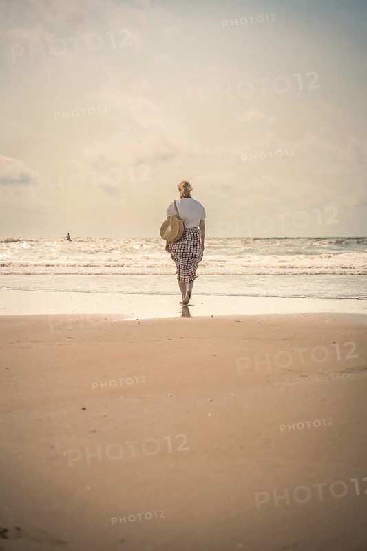 Woman on the beach in the evening sun, Zandvoort, Netherlands