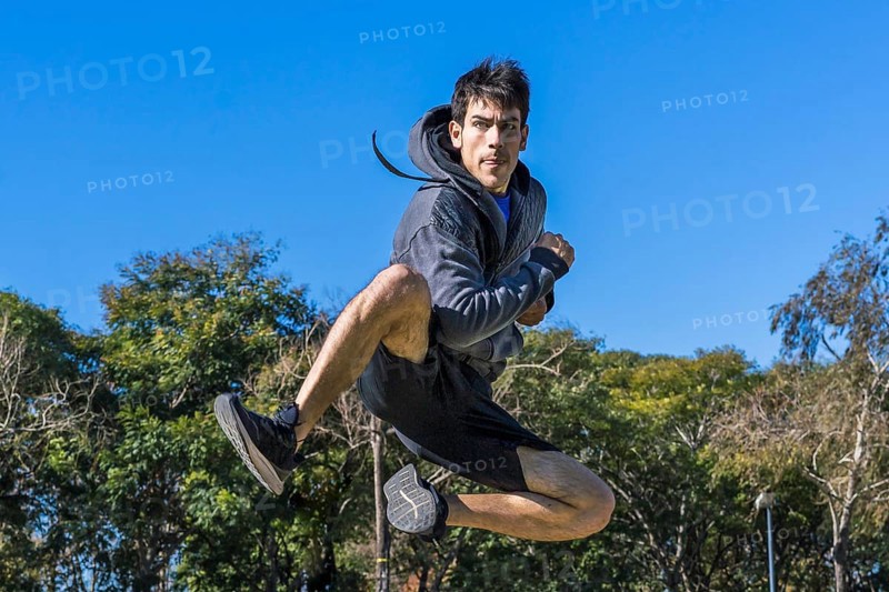 Martial arts fighter jumping in fly outdoors