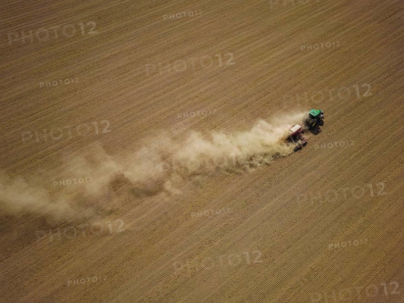 A tractor with a Horsch PRONTO DC 6 seed drill sowing in a dry field in late summer., Doma, Saxony, Germany, Europe