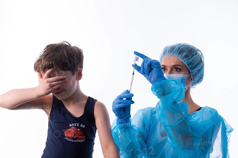 A little boy receives a vaccination, symbol motif