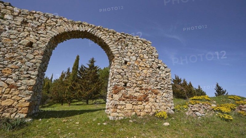 Roman aqueduct, stone arch, green meadow, blue sky, Madonie National Park, spring, Sicily, Italy, Europe