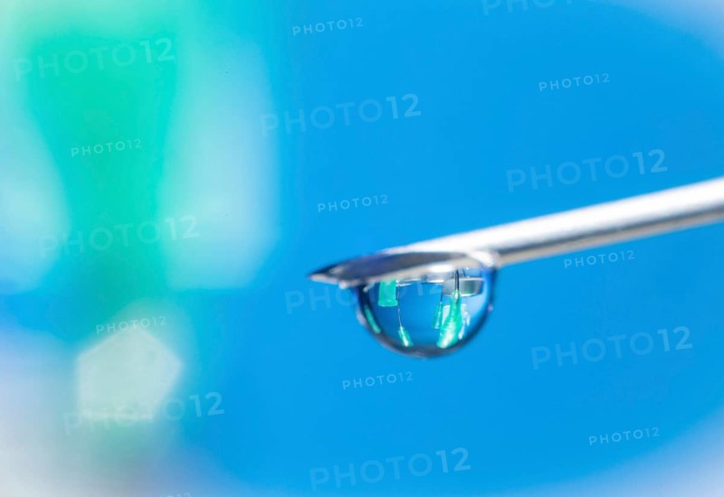 Macro image Covid vaccine, a drop of Moderna vaccine hangs on a vaccine needle