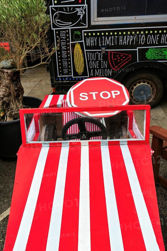 Stop sign in red and white striped soapbox at the Lafrowda Festival, St. Just in Penwith, Cornwall, England, Great Britain