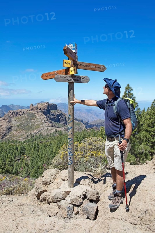 Hiker looking at the signpost in Parque Rural del Nublo, Las Palmas province, Gran Canaria, Canary Islands, Spain, Europe