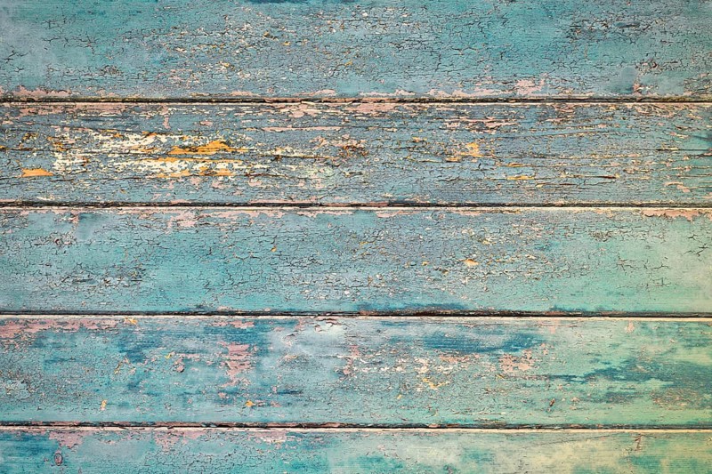 Grunge background with wooden dark teal blue colored old weathered planks with chipped paint