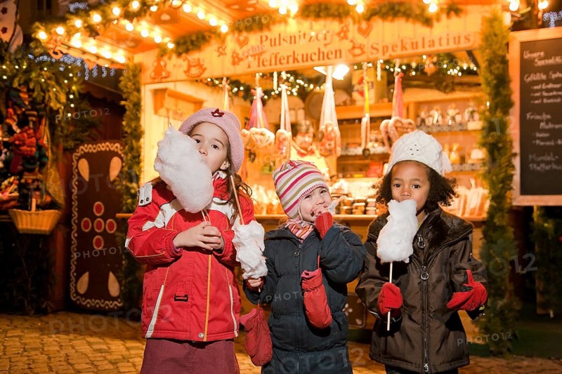 Children eat candy floss at the Striezelmarkt in Dresden