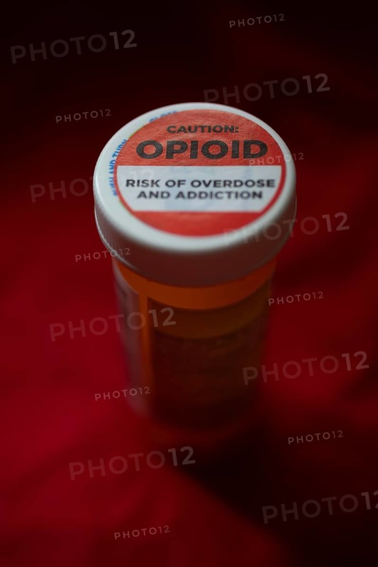 A label on a bottle of hydrocodone-acetamin opioid prescription pills warns against the danger of overdose and addiction