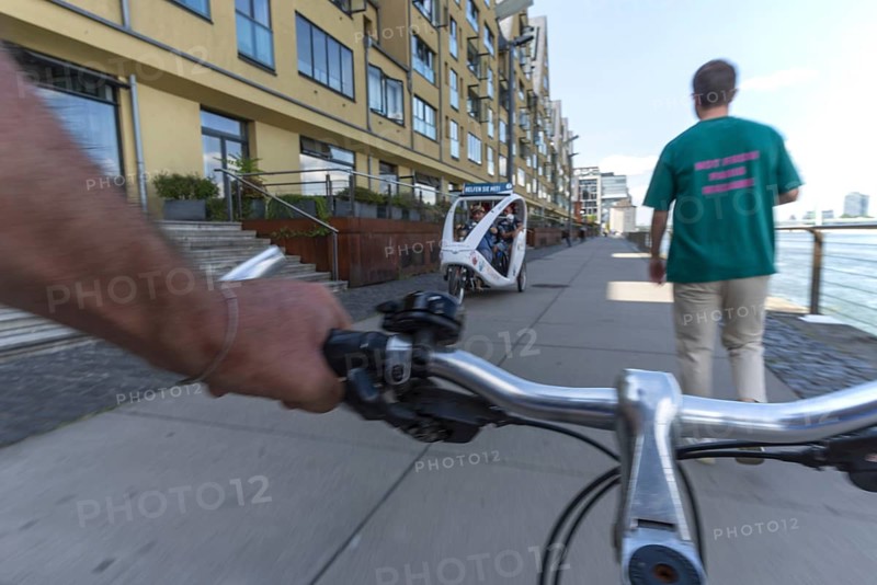 Cycling from the first-person perspective on a shared footpath and cycle path in Cologne, North Rhine-Westphalia, Germany, Europe