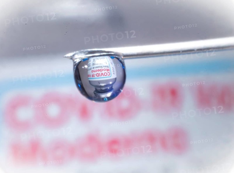 Macro image Covid vaccine, a drop of Moderna vaccine hangs on a vaccine needle