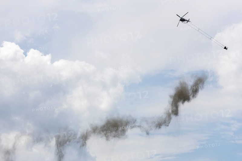 Symbolic image, climate change, helicopter, helicopter spreading finely painted limestone and ash against acid rain, container, soil protection liming, forest liming, Baden-Württemberg, Germany, Europe