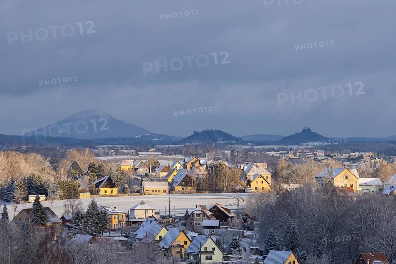 View of Porschdorf from the Gamrig in Saxon Switzerland, with the Rosenberg, Schrammsteine, Kaiserkrone and Zirkelstein behind