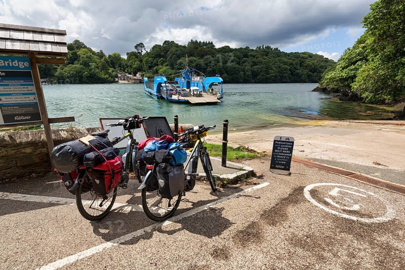 Two e-bikes, touring bikes at the King Harry Floating Bridge jetty, chain ferry on River Fal, National Cycle Route 3, Long Distance Cycle Route, Cornwall, United Kingdom, Europe