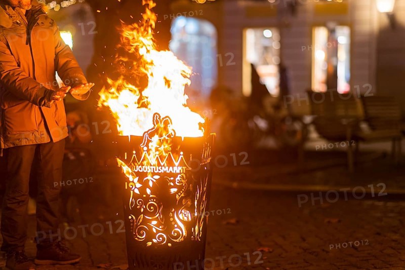 Neustädter Markt is home to one of Dresden's alternative Christmas markets. Visitors warm their hands at a fire barrel