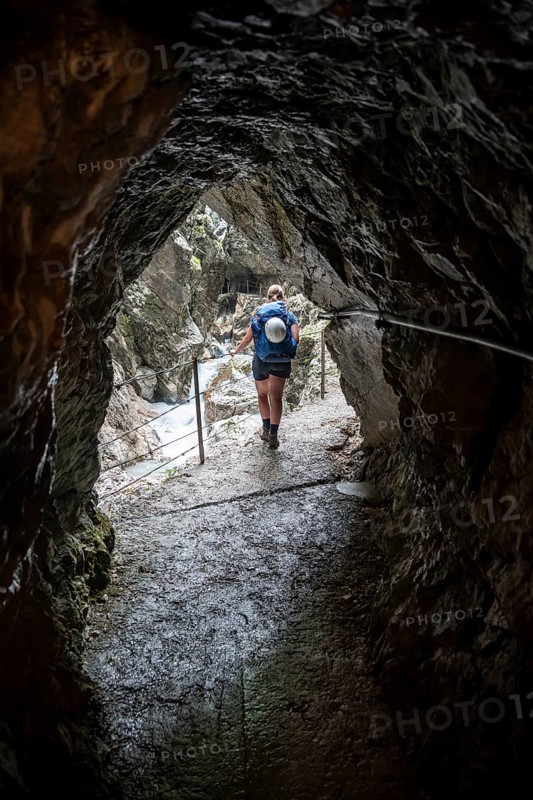 Hiker in a tunnel, Hammersbach flows through Höllentalklamm, near Garmisch-Partenkirchen, Werdenfelser Land, Upper Bavaria, Bavaria, Germany, Europe