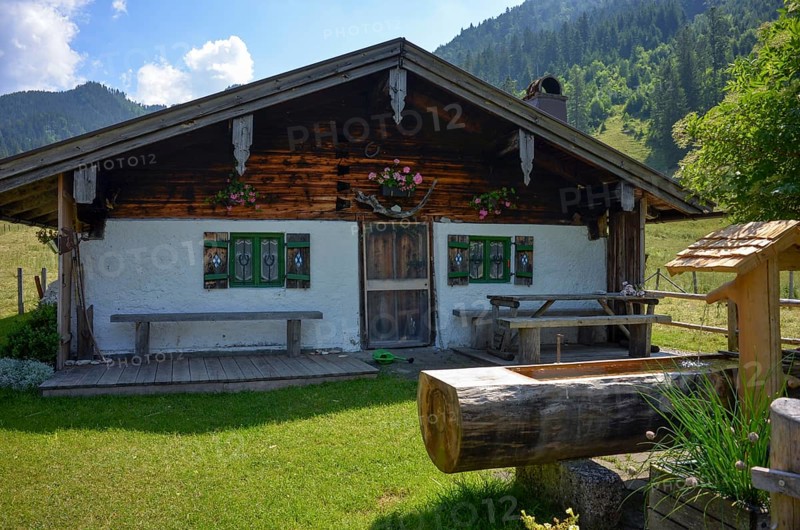 Detailed view of an idyllic alpine hut with well on the Rötelmoosalm, Chiemgau, Bavaria, Germany, Europe