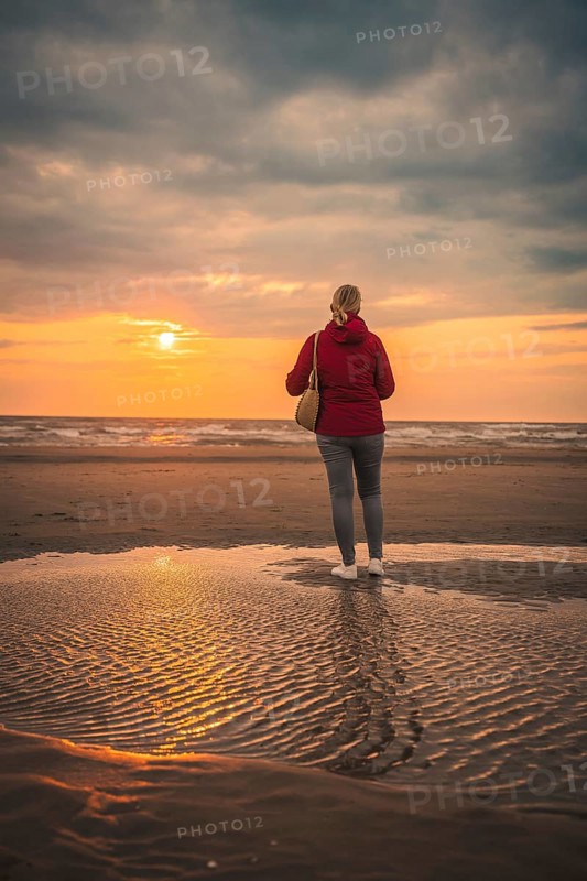 Tourist on the beach at sunset, Zandvoort, Netherlands