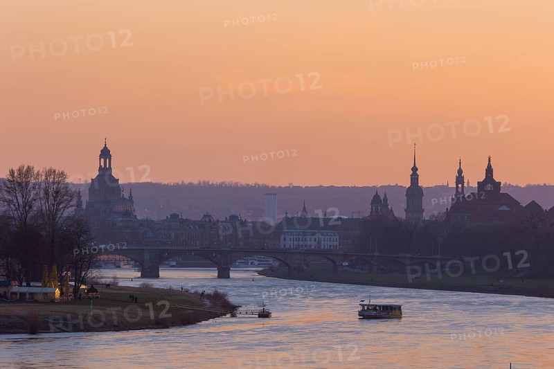 Evening sky over the old town of Dresden with the Church of Our Lady, the castle tower, the Hofkirche and the State Chancellery. In the foreground the Ferry Garden and the Elbe ferry