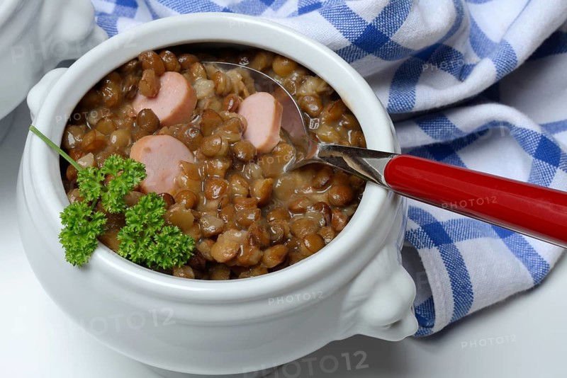 Lentil (Lens culinaris) dish with sausage slices in a bowl, lentil