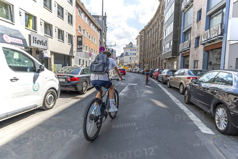 Cycling from a first-person perspective on a street in Cologne, North Rhine-Westphalia, Germany, Europe