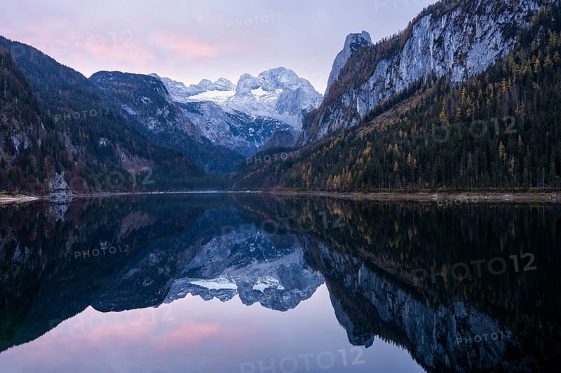 The Vordere Gosausee lake in autumn with a view of the Dachstein mountain range. The Gosaukamm on the right. Clouds in the sky, sunrise. Vorderer Gosausee, Gosau, Gosau valley, Salzkammergut, Upper Austria, Austria, Europe