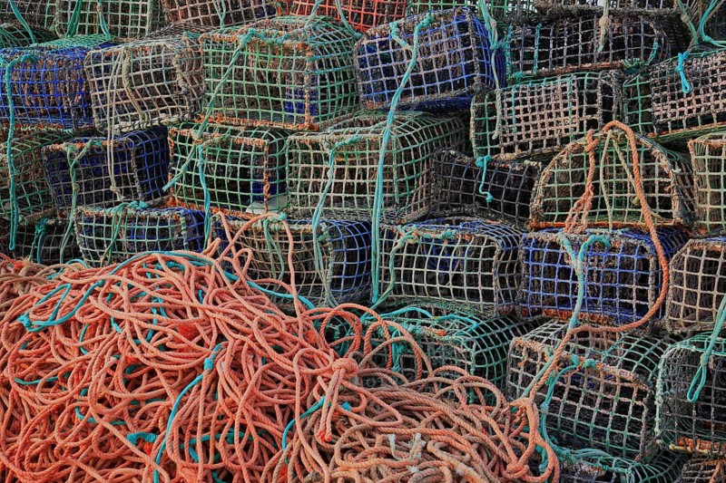 Lobster cages, lobster pots, here in Portugal, Algarve, Stacked fishing nets and ropes in different colours and textures, creating a chaotic yet vibrant atmosphere