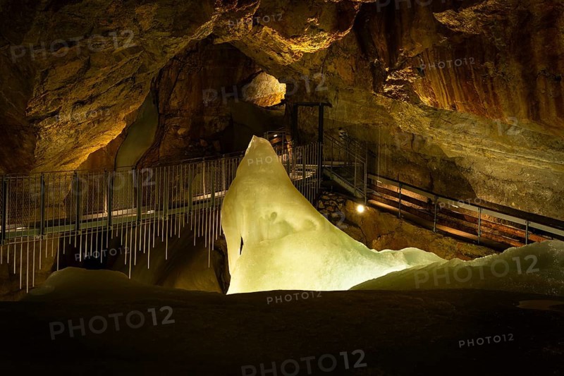 The illuminated Giant Ice Cave, a cave in the Dachstein massif. The suspension bridge in Tristandom. Obertraun, Salzkammergut, Upper Austria, Austria, Europe