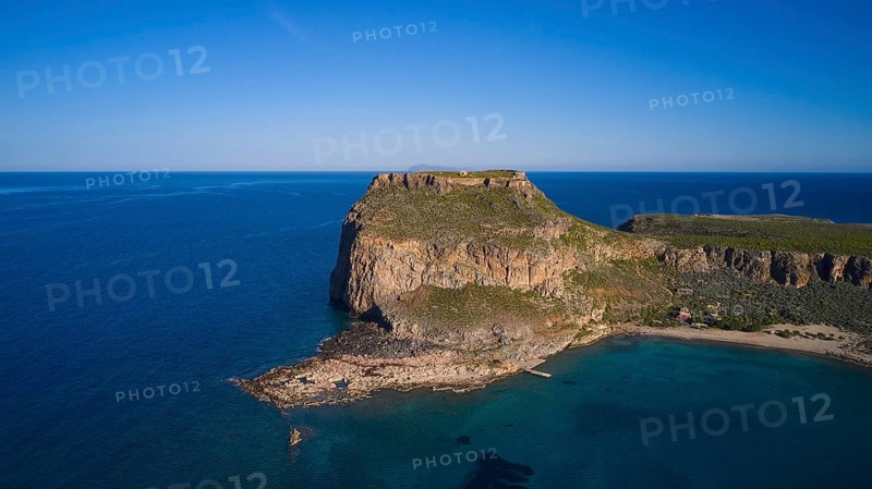 Drone shot, Rocky cliff coast with neighbouring beach and clear blue sky over the wide ocean, Venetian sea fortress, Gramvoussa, Gramvoussa peninsula, Pirate bay, Balos, Lagoon, Northwest Crete, Crete, Greek Islands, Greece, Europe