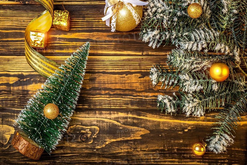 Christmas tree and toys on wooden background
