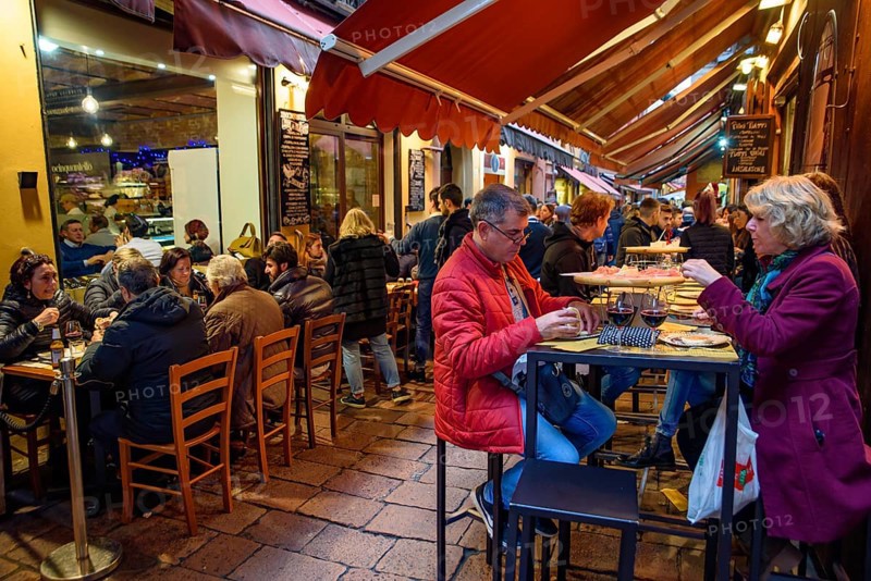 People eating and drinking on the street in Bologna, Italy, Europe