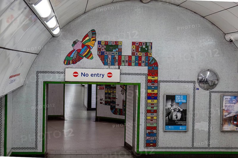 Interior view of an underground station with colourful wall art and No Entry sign, London, United Kingdom, Europe