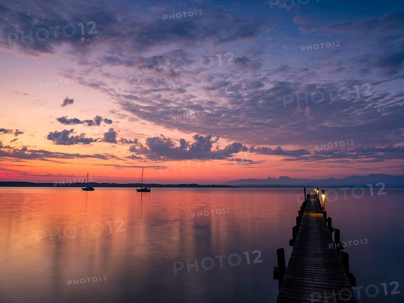 Sailing boats and jetty on Lake Chiemsee at dawn, with the Chiemgau Alps in the background, Chiemgau, Upper Bavaria, Bavaria, Germany, Europe