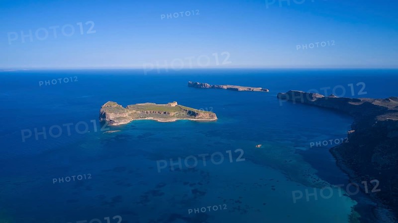 Drone shot, aerial view of an island with green area surrounded by blue sea and steep cliffs, Gramvoussa, Gramvoussa peninsula, Pirate Bay, Balos, lagoon, north-west Crete, Crete, Greek Islands, Greece, Europe