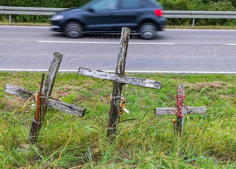 Cross on a country road, symbol of remembrance for three road accident victims. Laichigen, Baden-Württemberg, Germany, Europe