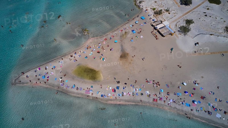 Overtourism, aerial view of a beach with many people and colourful umbrellas enjoying the sand and the sea, Elafonissi, lagoon, southwestern tip of Crete, Crete, Greek Islands, Greece, Europe